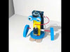 DIY Biped Robot Model with yellow motor body, blue foam feet, googly eyes, battery pack, and wooden support sticks – a fun STEM educational toy for kids.