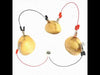 DIY fruit battery kit with copper and zinc plates connected to potatoes using alligator clips, powering a digital clock