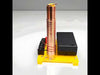 DIY Wireless Tesla Coil STEM kit with copper coil, yellow baseplate, 3×AA battery holder, LED indicator, transistor, resistor, wiring terminals, insulating tube, and user manual for hands-on learning.