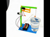 DIY water level sensor science project for class 5 showing a float ball in a water cup connected to a microswitch, LED, and battery setup on a blue base for overflow detection.